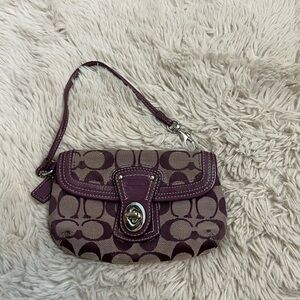 Coach wristlet. Purple canvas signature pattern with leather trim.